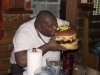 fat+guy+eating+giant+hamburger.jpg